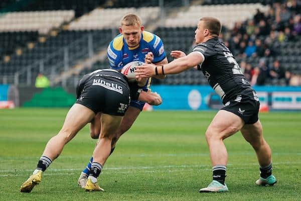 Jack Brown, right with teammate Jordan Lane, tackles Mikolaj Oledzki during Hull FC's defeat by Leeds Rhinos last month. Picture by Alex Whitehead/SWpix.com.