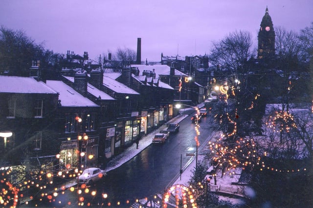 Christmas decorations at night looking south up Queen Street towards the Town Hall in December 1968. Shops are lit up on the left hand side of the road and Scatcherd Park can be seen on the right. Snow on the ground and rooftops completes this traditional-looking Christmas scene.