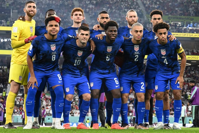 Tyler Adams and the USMNT team pose for a photograph before their victory versus Iran (Photo by PATRICK T. FALLON/AFP via Getty Images)