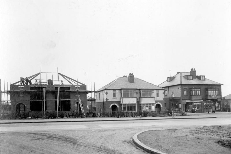 Newly built houses located between Austhorpe Grove and Austhorpe Avenue. Austhorpe Post Office can be seen to the right of the photograph. A sign in front of the shops reads 'Villas for sale, Sedgwick builders'. School Lane is in the foreground. Pictured in January 1936.