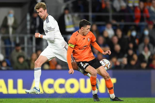 GOLD COAST, AUSTRALIA - JULY 14: Patrick Bamford of Leeds United and Scott Neville of the Roar compete for the ball during the 2022 Queensland Champions Cup match between Brisbane Roar and Leeds United at Cbus Super Stadium on July 14, 2022 in Gold Coast, Australia. (Photo by Albert Perez/Getty Images)