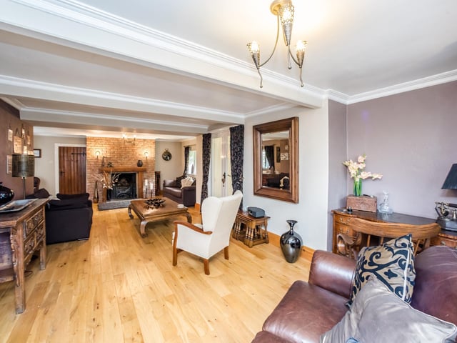 A stunning beamed reception room with feature fireplace.