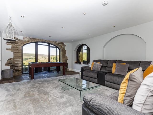 A games room adjoins this seating area within the property.