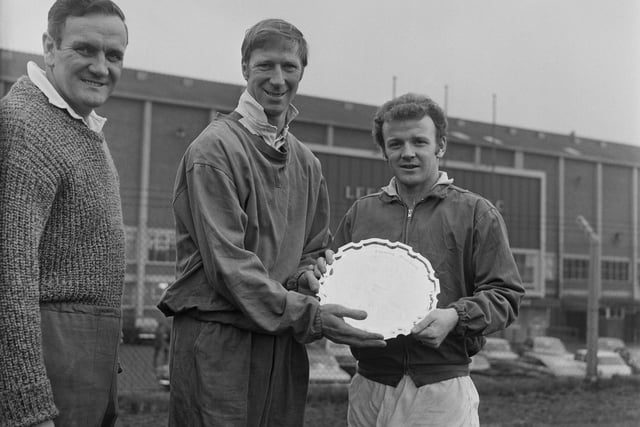 Scottish soccer player Billy Bremner and English soccer player Jack Charlton of Leeds United FC holding the Charity Shield together with their manager Don Revie, at Elland Road, Leeds, UK, 6th December 1969. (Photo by Evening Standard/Hulton Archive/Getty Images)