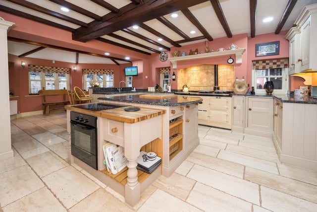The spacious family open plan living/dining kitchen has a comprehensive range of handmade units with marble preparation surfaces and matching island with butcher’s block and integrated split-level cooker.