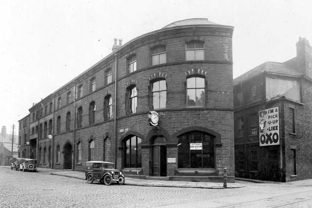 The new premises of Simms Motor Units Ltd. on the corner of Hunslet Lane (foreground) and South Brook Street, in the building that was once the Yorkshire Brass & Copper works. Features are Simms Clock and a Simms Magnetos works vehicle parked outside. To the right, with an Oxo advertisement on the wall, are the rears of houses facing on to South Terrace. Pictured in January 1935.