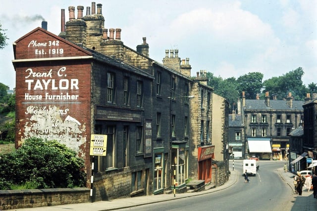Looking down the last part of Scatcherd Hill into Morley Bottoms in July 1965 only four months before the buildings on the left hand side were demolished. These were a mixed jumble going back onto Dawson Hill, and over the door that Lawsons had as pawnbrokers was the date 1848. Obscured from the road behind these blocks was a good example of a rag warehouse with living quarters, later changed into a Chinese then Indian restaurant. Some of the furniture sold by Stanley Trousdale across the road was stored in the old buildings; some stored fireplaces and there was an old boot and shoe repairers.