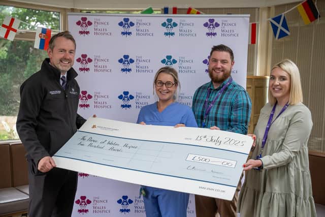 Gavin McCarthy handing the cheque to the team at The Prince of Wales Hospice