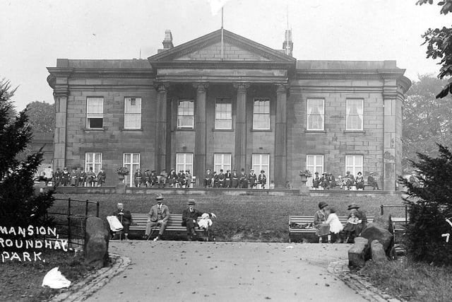 Many people are seated in front of the Mansion in Roundhay Park. Their manner of dress would indicate that the image dates from circa 1920s.