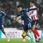 'STILL WAITING': For Joel Piroe, centre, to 'consistently take flight' from the four regular starters in Leeds United's attacking quartet, the Dutchman pictured battling it out with  
 Sunderland's Jobe Bellingham in Tuesday night's 1-0 Championship defeat at the Stadium of Light. Photo by Mike Egerton/PA Wire.