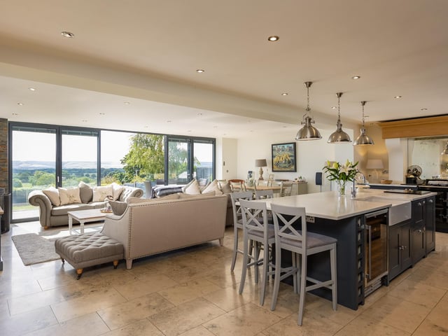 The linked kitchen with dining and family room has fitted units with a Range cooker and an island unit including a breakfast bar.