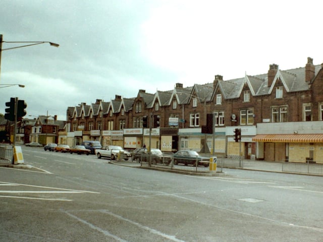 Roundhay Road seen from the junction with Harehills Road. All the shops on the parade on the right are boarded up as a result of a series of riots which have taken place in nearby Chapeltown. Shops visible include Sea Land Foods on Roundhay Road and Barclays Bank.