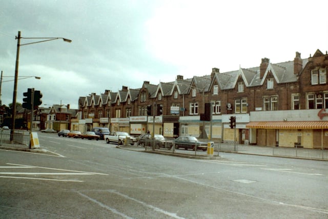 Roundhay Road seen from the junction with Harehills Road. All the shops on the parade on the right are boarded up as a result of a series of riots which have taken place in nearby Chapeltown. Shops visible include Sea Land Foods on Roundhay Road and Barclays Bank.