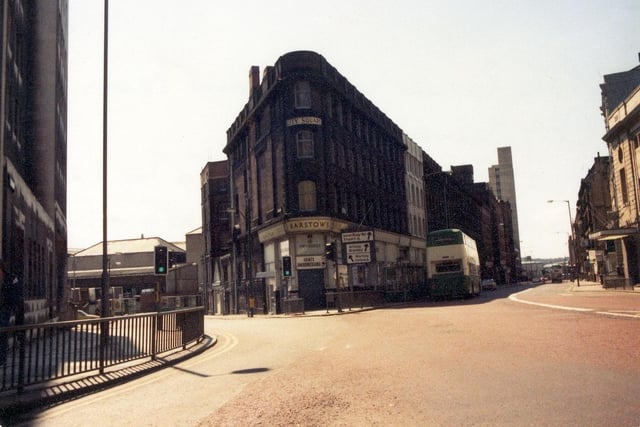 A view from City Square, showing the junctions with Aire Street, left, and Wellington Street, right, in May 1980. In the centre the triangular building houses numbers 56 to 62 Aire Street and numbers 11 and 11A Wellington Street. Barstows Gents Hairdressing, founded in the early 1900s, is visible on the corner and had occupied this building since 1910. Barstow's was a family run business and, when it opened, offered 4d shaves and 10d haircuts (one shilling on a Saturday!) The shop also sold confectionery and operated as a newsagents. Eventually, chiropody was added to the services. Just before the shop closed for re-development of the site in the June of 1980 haircuts had risen to £1.30! On demolition of these buildings work began on the red brick six storey City Square House, which was completed in 1983.