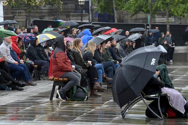 Such was the extent of the desire to pay public respect to her, people descended upon the city centre armed with umbrellas, ponchos and waterproof coats to ensure they could watch the live screening. Image: Simon Hulme