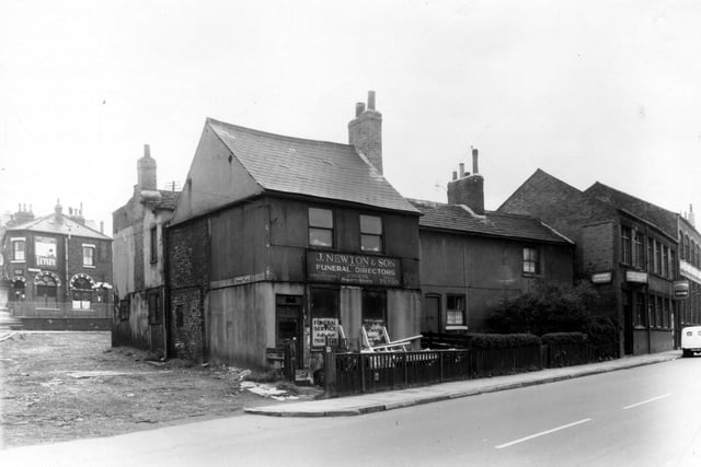 Elland Road in September 1960. Rothsay Place is on the left in this view, looking onto Cemetery Road. The off licence shop with the Tetley sign is at the corner with Little Town Lane and is 14 Cemetery Road. Number 115 Elland Road, premises of J. Newton and Son, funeral directors and joiners. Two cottages to the right are 117, 119. Next 121 a factory Northern Chairworks Ltd, wholesale upholsterers and frame-makers. Sharing this address is the firm of Waterhouses who made sweets and toffees. Large factory on the right is also part of the upholstery works, called Moorhead Works.