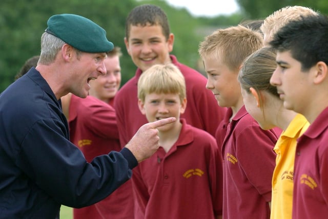 Former Cardinal Heenan High School pupil Corporal Marty Quinn gives orders to pupils during a Royal Marines training session in June 2004.