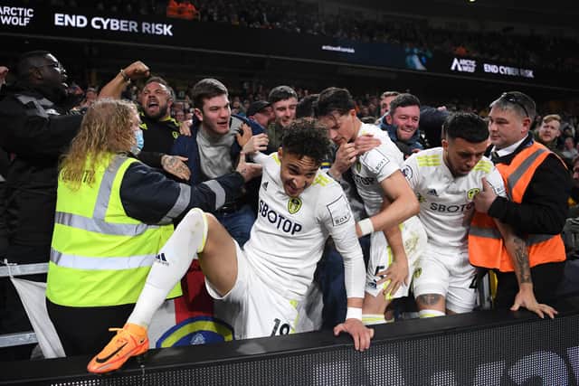 WOLVERHAMPTON, ENGLAND - MARCH 18: Rodrigo Moreno of Leeds United celebrates with fans after scoring their side's second goal during the Premier League match between Wolverhampton Wanderers and Leeds United at Molineux on March 18, 2022 in Wolverhampton, England. (Photo by Laurence Griffiths/Getty Images)