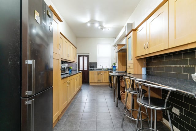 The modern fitted kitchen includes a breakfast bar and plenty of modern appliances.