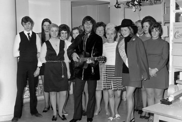 Cliff Richard is pictured at  Green Shield Stamps on Eastgate in April 1970. He is surrounded by a group of staff dressed in typical fashion of the time