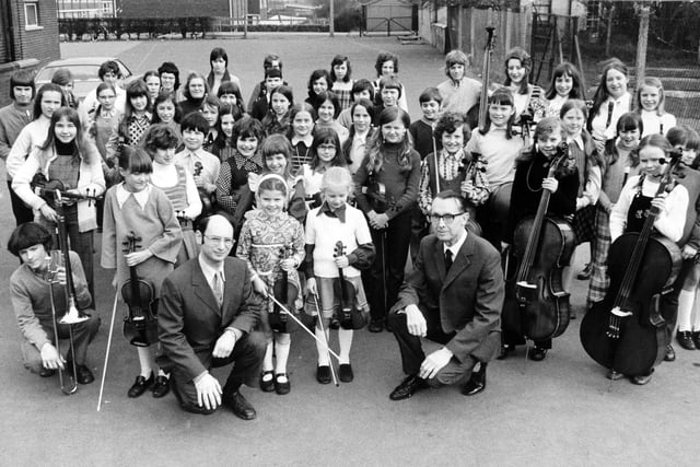 Members of the East Leeds Youth Orchestra pictured in March 1974 with Michael Landa (left) conductor of the recorder group, and Mr. J. Renhard, the orchestra's conductor.