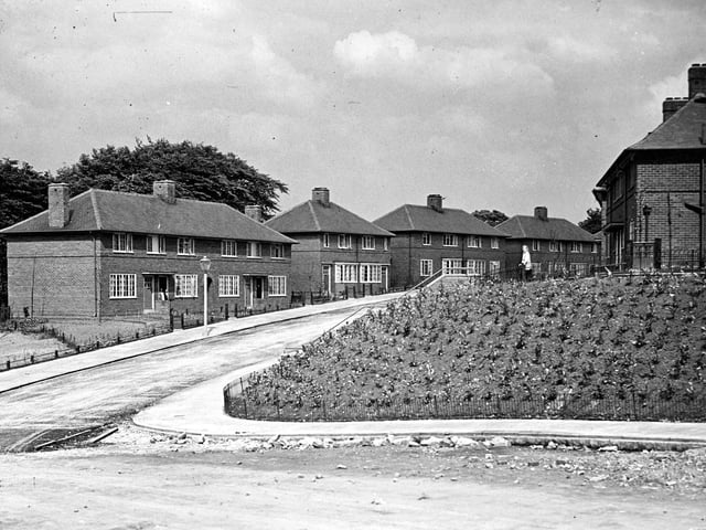 Pre-war traditional houses on the Sandford Housing Estate, part of the City of Leeds Corporation Housing Scheme. The view is looking towards Broadlea Terrace from Broadlea Hill, showing semi-detached houses numbered in descending order from 168 Broadlea Terrace on the left, with 167 and 165 on the right.