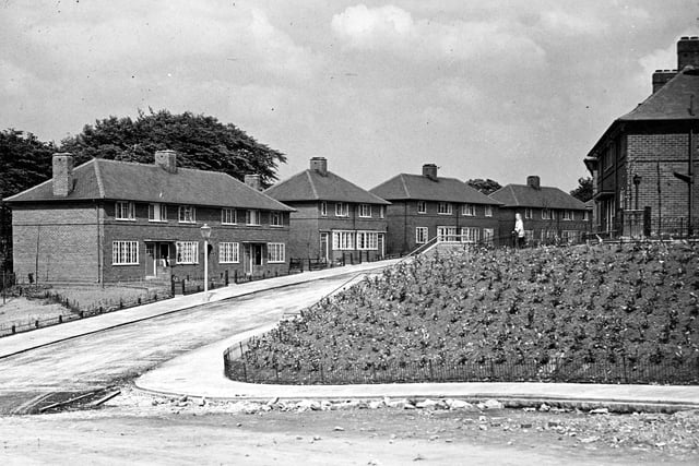 OPre-war traditional houses on the Sandford Housing Estate, part of the City of Leeds Corporation Housing Scheme. The view is looking towards Broadlea Terrace from Broadlea Hill, showing semi-detached houses numbered in descending order from 168 Broadlea Terrace on the left, with 167 and 165 on the right.