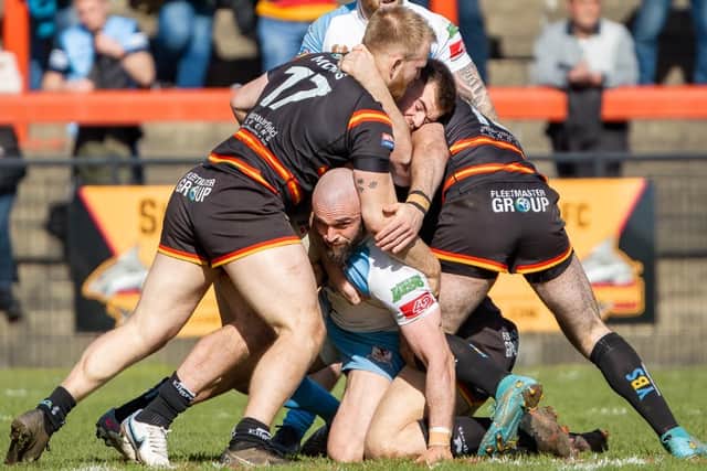 Rams' defence, led by Elliot Morris (number 17), get to grips with Hunslet’s Adam Ryder. Picture by Paul Whitehurst.