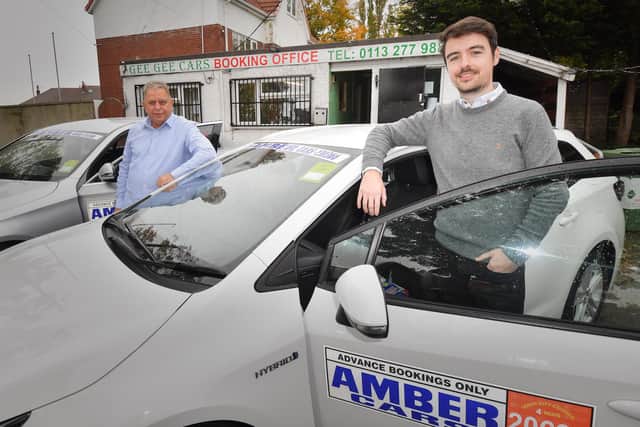 Abdul Waheed, owner of Gee Gee cars (left) and Chris Neary, Amber Cars Regional Director, pose outside the offices of Gee Gee cars after the company was acquired by Amber cars