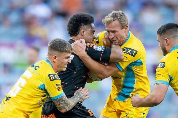 Derrell Olpherts, playing for Castleford, is tackled by Rhinos' Corey Johnson and Matt Prior at the 2022 Magic Weekend in Newcastle.  Picture by Allan McKenzie/SWpix.com.