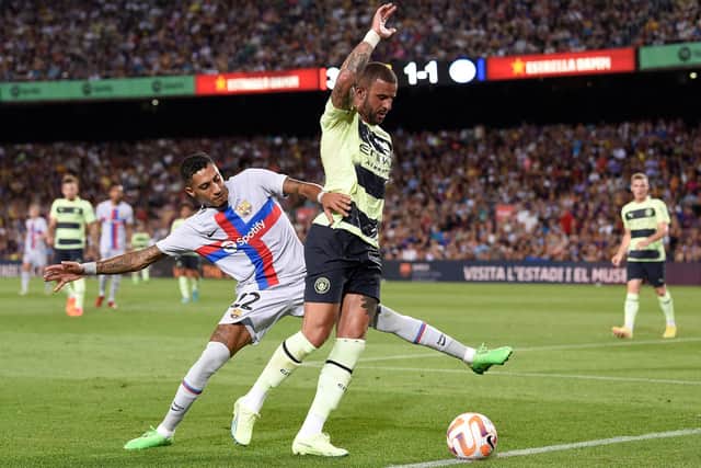 Barcelona's Brazilian forward Raphinha (L) fights for the ball with Manchester City's English defender Kyle Walker during the friendly football match between FC Barcelona and Manchester City, at the Camp Nou stadium in Barcelona on August 24, 2022. (Photo by Josep LAGO / AFP) (Photo by JOSEP LAGO/AFP via Getty Images)