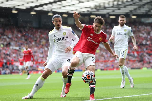 MANCHESTER, ENGLAND - AUGUST 14: Daniel James of Manchester United is challenged by Pascal Struijk of Leeds United during the Premier League match between Manchester United  and  Leeds United at Old Trafford on August 14, 2021 in Manchester, England. (Photo by Alex Morton/Getty Images)