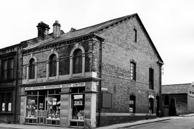 The Stanningley branch of the Leeds Industrial Co-operative Society Ltd at number 105 Town Street. Goods for sale include maccaroni cheese. On the right is Wood's Row leading up to Vernon Place. Pictured in August 1963.