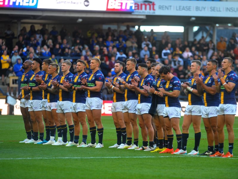 Leeds Rhinos players join in a minute's applause for former England coach John Kear - who died suddenly last weekend - before the 24-16 win against St Helens at AMT Headingley.