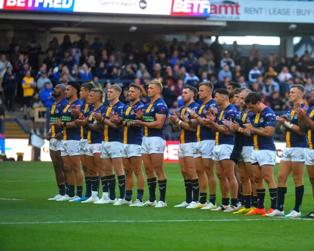 Leeds Rhinos players join in a minute's applause for former England coach John Kear - who died suddenly last weekend - before the 24-16 win against St Helens at AMT Headingley.