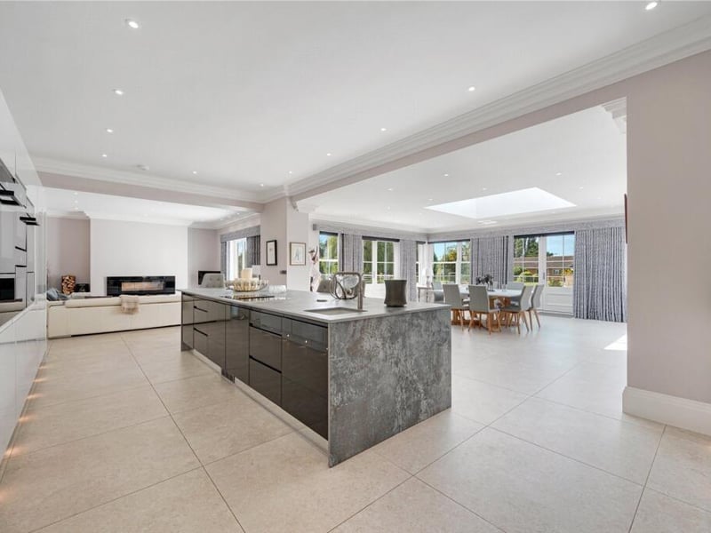 The open plan space spans nearly 50 ft, encompassing the kitchen/breakfast room, garden room, and dining room, with French and bi-fold doors leading to a south and west-facing terrace.