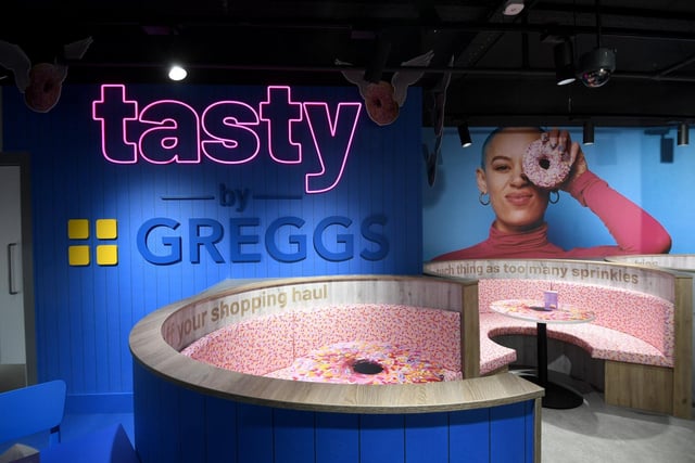 The 117-seat Tasty by Greggs café is now open on the first floor of the Primark in Trinity Leeds shopping centre. The new Leeds branch features vibrant interiors and backdrops which are designed for Instagram and TikTok feeds. Customers can snap a selfie in the shop’s doughnut seating booths or on its Sausage Roll swing.