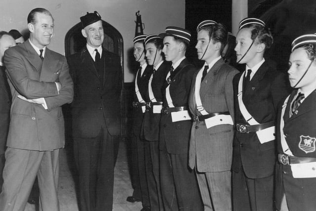 The Duke of Edinburgh chats with members of a drill squad formed by the 8th Leeds Company of the Boys Brigade at Burley Methodist Church in May 1958. He is pictured with company captain  E. L. Peck.