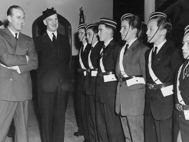 The Duke of Edinburgh chats with members of a drill squad formed by the 8th Leeds Company of the Boys Brigade at Burley Methodist Church in May 1958. He is pictured with company captain  E. L. Peck.