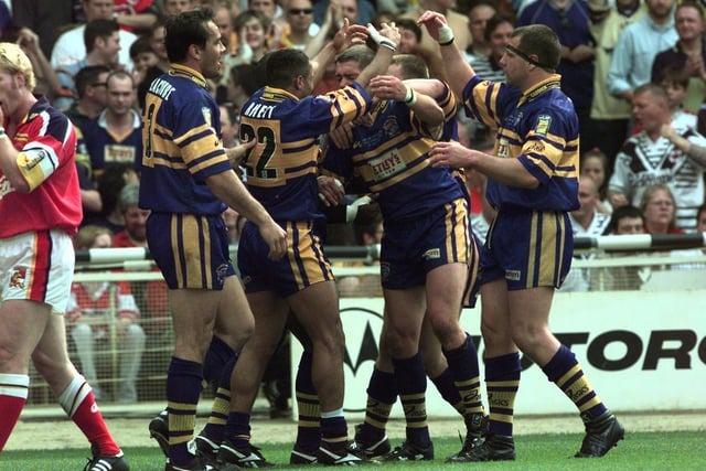 Rhinos players celebrate one of Leroy Rivett's then-record four tries in the win over London Broncos.