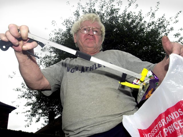 Community champion Barry Gibney picks up rubbish along Intake Lane in August 2003.