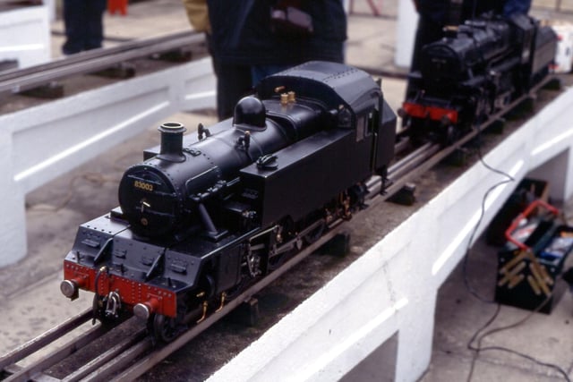 A close-up of a black-painted locomotive.