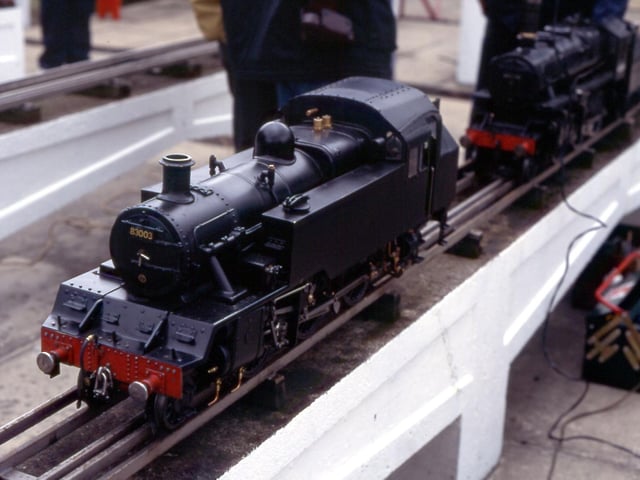 A close-up of a black-painted locomotive.