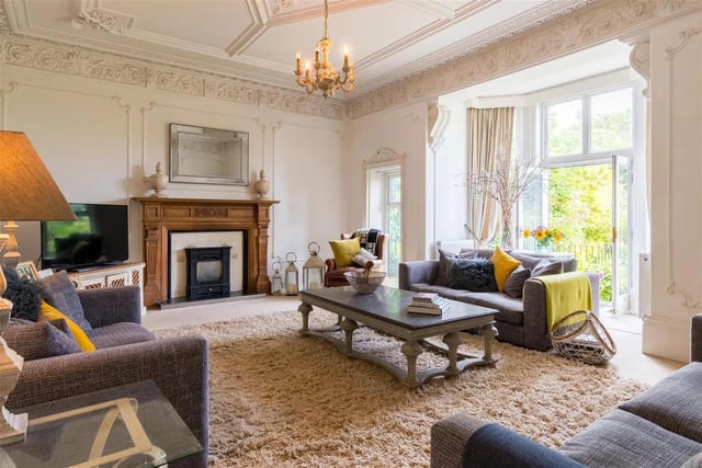 The formal living room is of excellent proportions with a deep window overlooking the patio and garden. Ornate ceilings and frieze are two examples of Victorian embellishment complemented by a ceiling rose and wall panelling, along with the carved wooden fireplace.
