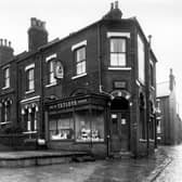 An off-licence shop at the corner of Cemetery Road and Little Town Lane. Cemetery Road is on the left. The shop was one of Tetleys outlets, run by James Oliver Fletcher. The window has been built across the original frontage, the arch of the existing window can be seen behind. Little Town Lane is on the right, next to the off licence is a fish and chip shop. The adjacent house was 1 Landsdowne Mount, the end of which can be seen. Pictured in September 1960.