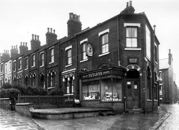 An off-licence shop at the corner of Cemetery Road and Little Town Lane. Cemetery Road is on the left. The shop was one of Tetleys outlets, run by James Oliver Fletcher. The window has been built across the original frontage, the arch of the existing window can be seen behind. Little Town Lane is on the right, next to the off licence is a fish and chip shop. The adjacent house was 1 Landsdowne Mount, the end of which can be seen. Pictured in September 1960.