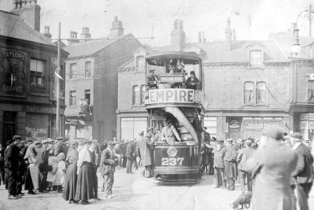 The first tram on the new Morley Tramway route passes through Morley Bottoms on it's way back to Leeds. This was a trail run to test the route before the official opening three days later, but crowds are gathered to watch as the no. 237 Dick Kerr tram goes past. Pictured in 1911.