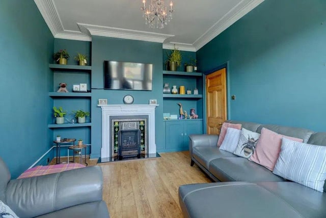 The statement living room has a gas fire and a large south-facing bay window.