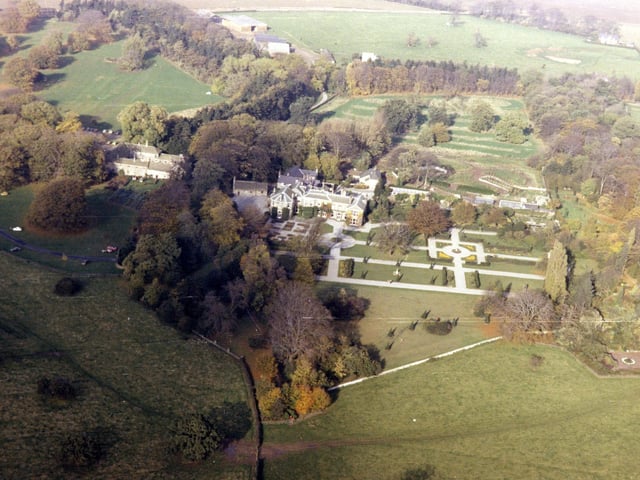 An aerial view of Lotherton Hall taken in 1979 from the Skyview Aerial Archive. The Hall is visible in the centre with its formal gardens. Behind Lotherton Hall to the right the Bird Garden is under construction.