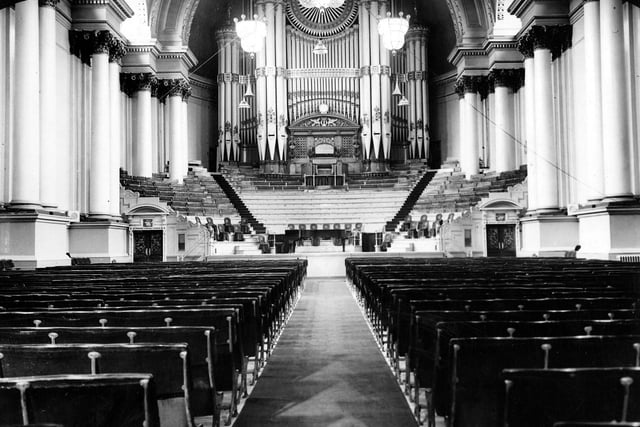 Looking from the south entrance of the Victoria Hall towards the magnificent organ at the north end. It was designed by Londoner, Henry Smart, and William Spark of Leeds. Cuthbert Brodrick designed the layout of the hall to accommodate 8,000 'standers'. When William Spark himself became organist he was paid an annual salary of £200 to perform at no less than 100 public concerts per year. The original 900 seats were purchased in July 1858 in preparation for the grand opening on September 7. They cost 3/6d each, total cost: £157 10/- from the firm of Francis Danby.